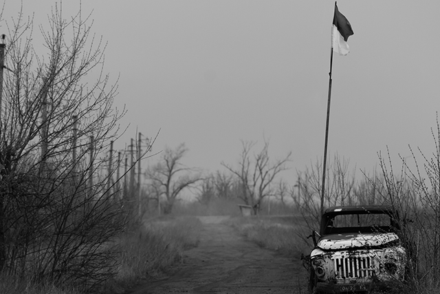 La Guerra en Ucrania, coche quemado con la bandera de Ucrania
